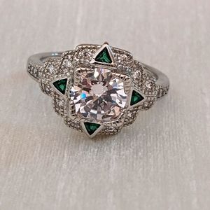 Vintage-inspired zircon ring with green accents.
